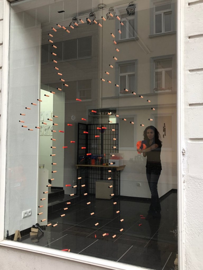 Starting the performance - shooting the toy guns to the window